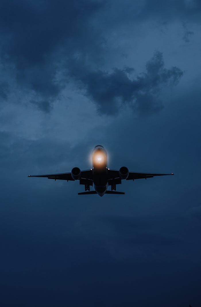 A dramatic shot of an airplane against a moody night sky in Istanbul.